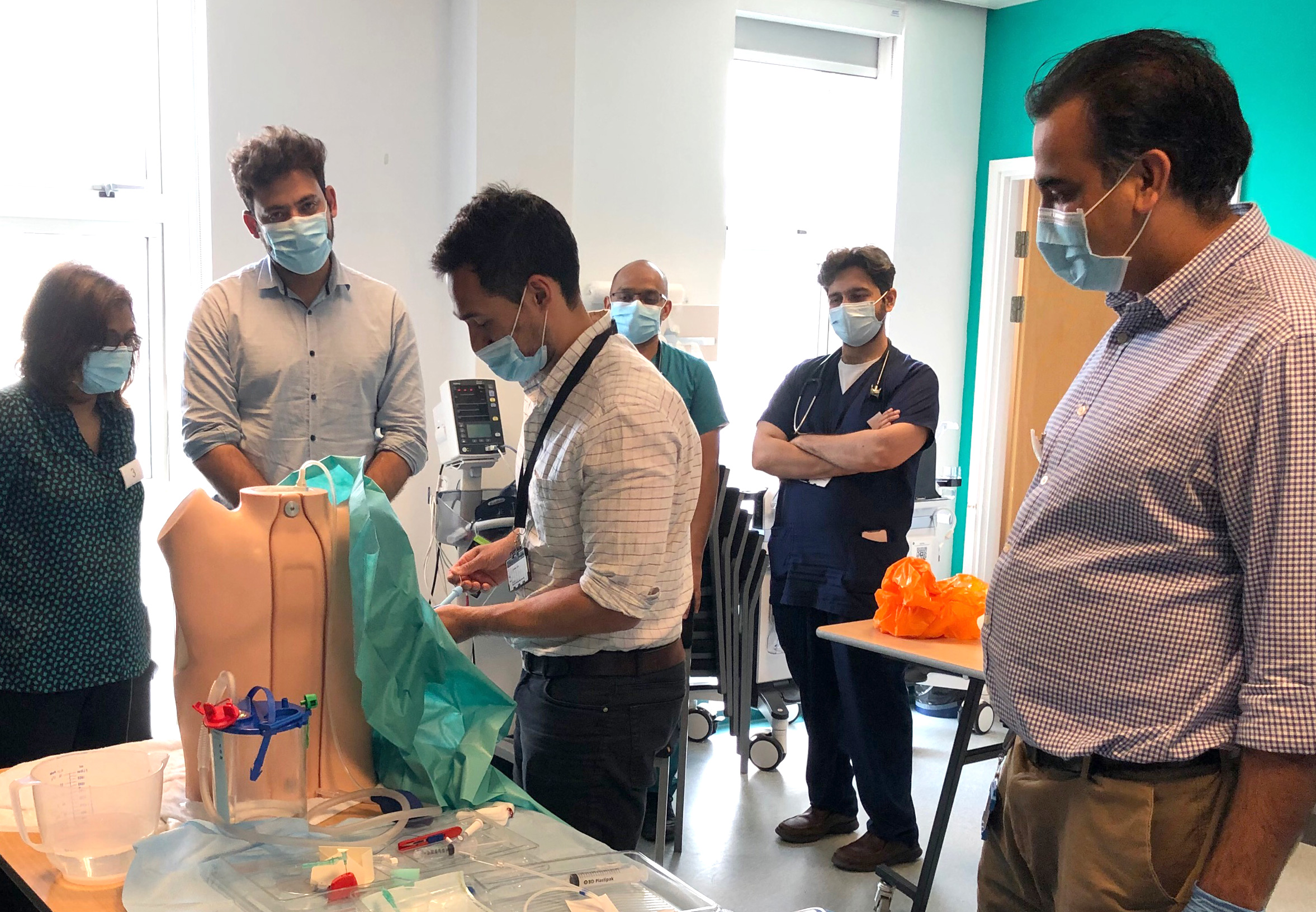 This is a photograph showing staff in a chest drain workshop