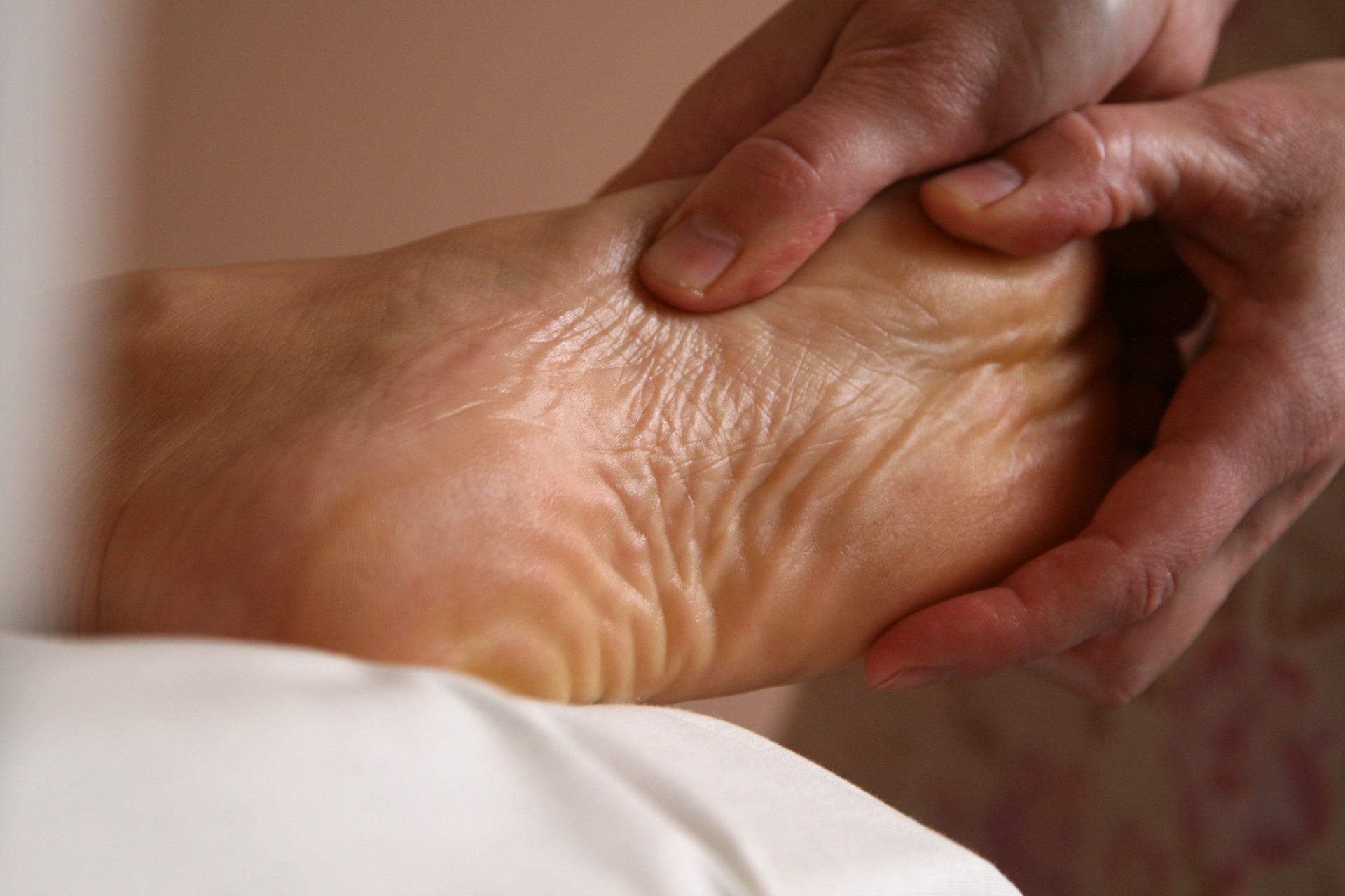 A physiotherapist massaging a patient's foot